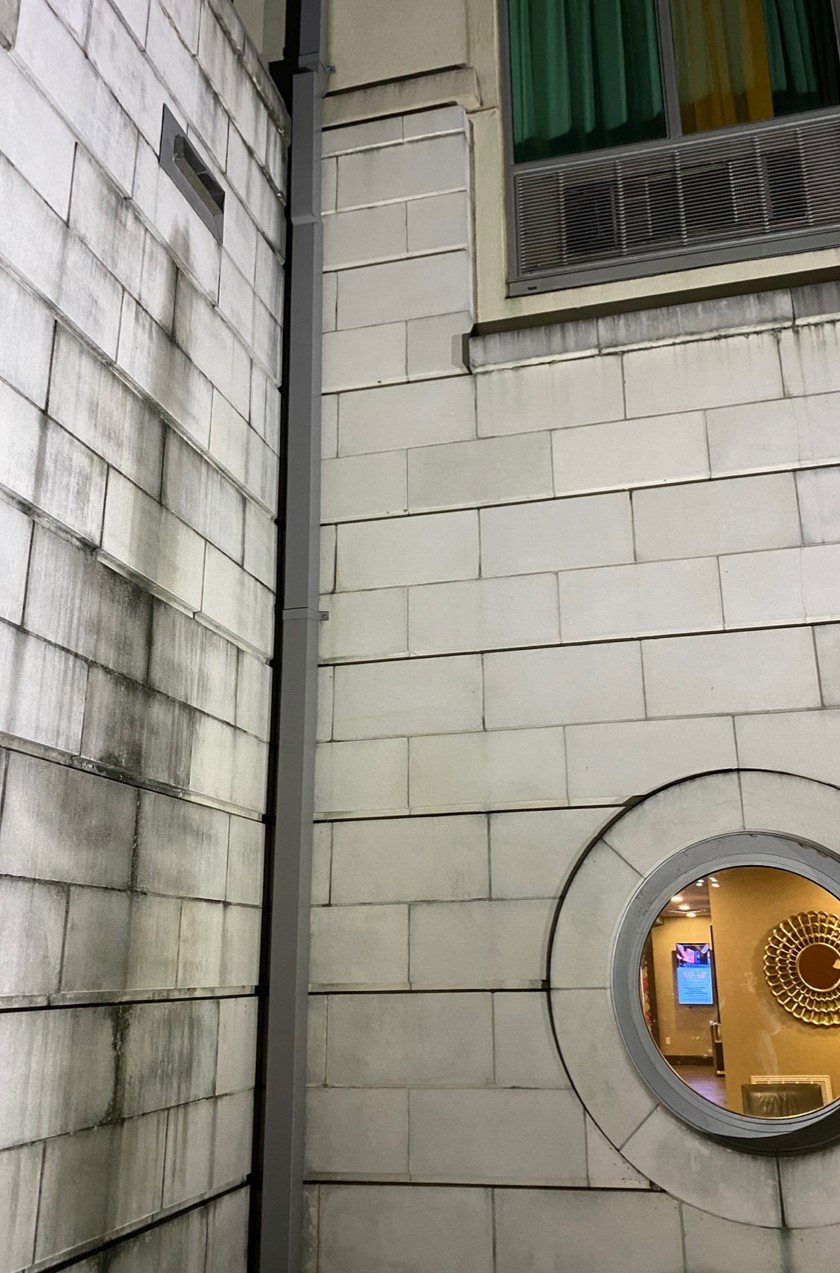 Before pressure washing - dirty brick wall